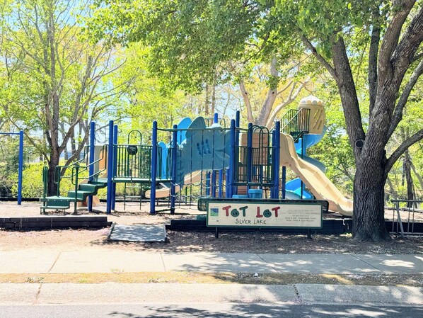A playground with a slide and climbing structures.