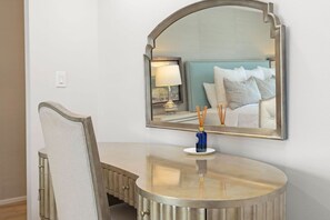 A hotel room with a round vanity, a mirror, a lamp, and a bed with pillows. - Seaside Retreat - 3BR/3BA Gulf-Front Home - Private Pool & Beach Walkover - Sleeps 10 (Santa Rosa Beach)