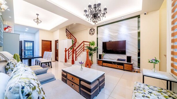 A modern living room with a sofa, coffee table, TV, and a staircase. - man man (Wujie)