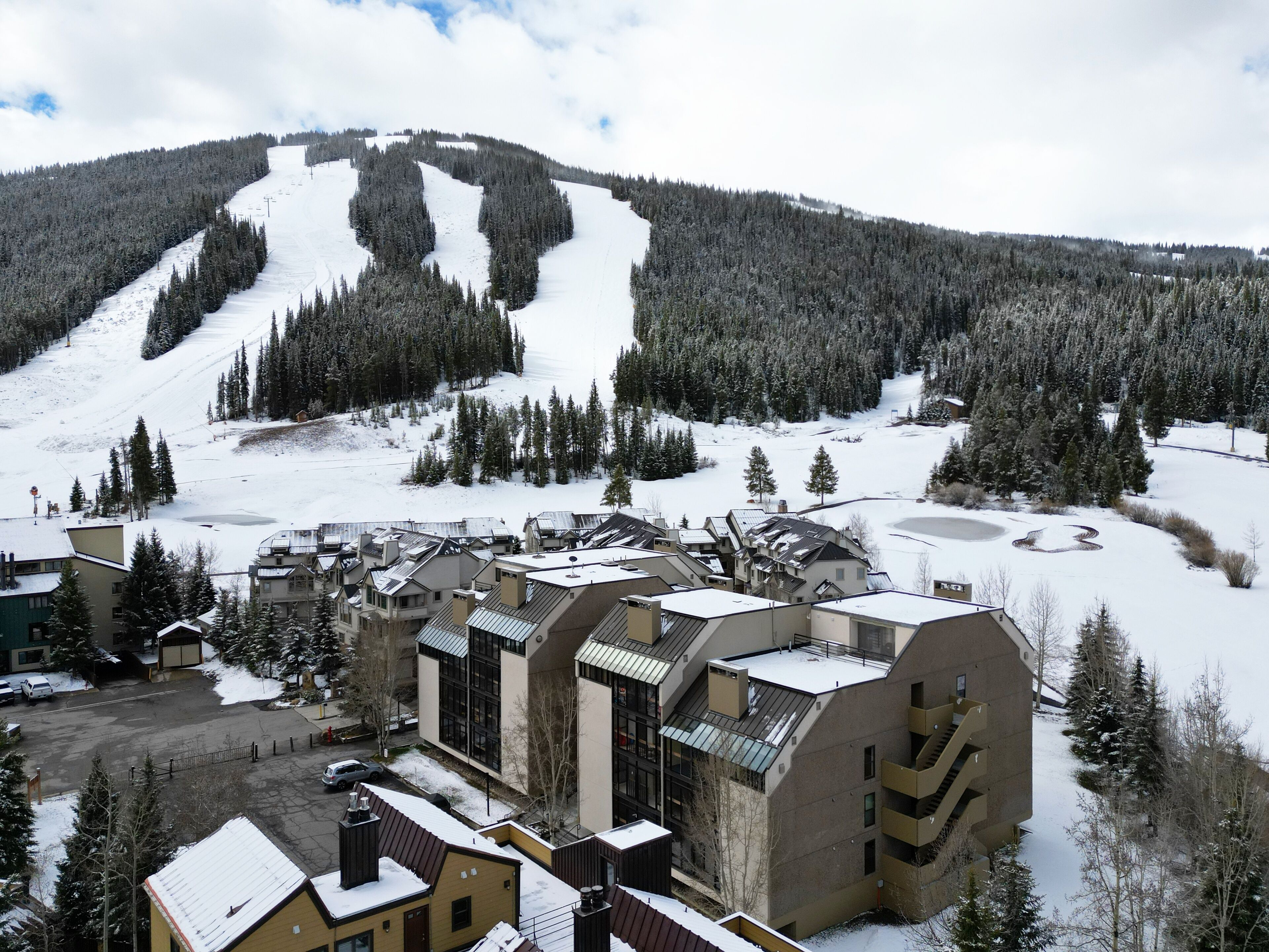 A ski resort with buildings and a ski slope.