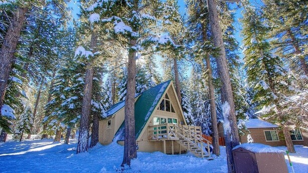 A cabin surrounded by snow-covered trees. - Lodgepole Chalet 3 Bedroom Home by RedAwning (South Lake Tahoe)