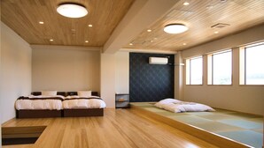 A modern hotel room with two beds, a built-in bench, wooden flooring, and large windows. - Tabist Hotel Chouseikaku (Yatsushiro)
