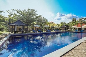 A swimming pool with lounge chairs and a gazebo. - Grand Ball Beach Garden (Penida Island)