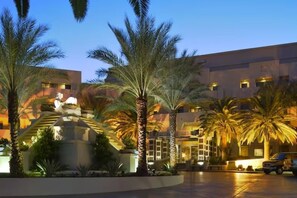 Experience the serene atmosphere of our lobby, surrounded by lush greenery and a striking palm tree sculpture.