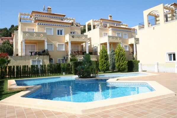 A residential building with a swimming pool, balconies, and a tiled patio area. - Green I - 4A (Pedreguer)
