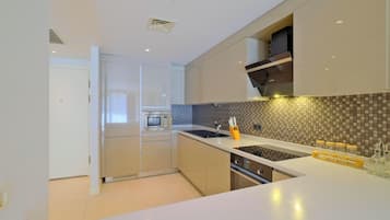 Deluxe Apartment, 1 Bedroom | Private kitchen | Fridge, stovetop, dishwasher, cookware/dishes/utensils