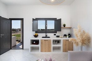 Suite, 1 Bedroom (Avgi) | Living area | 42-inch Smart TV with satellite channels, TV, fireplace - Almira Luxury Suites (Santorini)