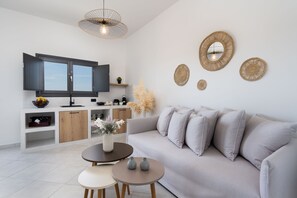 Suite, 1 Bedroom (Avgi) | Living area | 42-inch Smart TV with satellite channels, TV, fireplace - Almira Luxury Suites (Santorini)