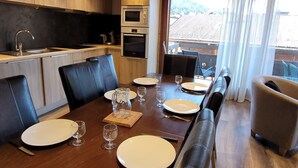 A modern kitchen with a dining area.