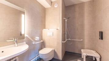 A modern bathroom with a sink, toilet, and shower.
