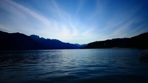 A calm lake with mountains in the background. - Beautiful apartment 100 meters from the lake! (Annecy)