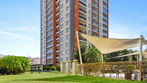 A high-rise residential building with multiple balconies and a modern architectural design. - InCity Charming Studio (Bucharest)
