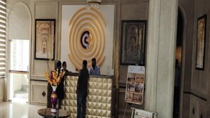 A reception area with a geometric patterned wall, a central circular design, and framed artwork on the walls. - Click Collection Jaipur (Jaipur)