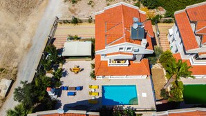 An aerial view of a residential area with a swimming pool, outdoor seating, and a satellite dish. - Infinity Sunshine Villa (Mugla)