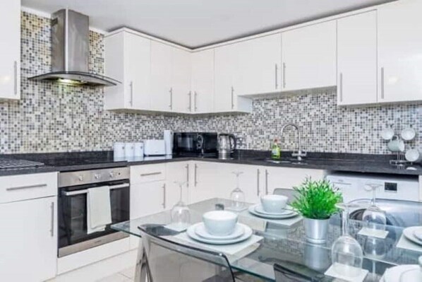 Enjoy cooking in this fully equipped kitchen with a stove, oven, microwave, and sink.