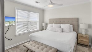 A bedroom with a bed, a ceiling fan, a window with blinds, and a nightstand with a lamp. - Newly Renovated-Community Pool and Tennis Courts (Santa Rosa Beach)