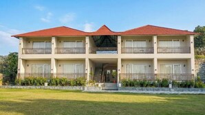 A two-story building with a red-tiled roof, balconies, and a covered entrance. - Kumbhal Exotica Resort Kumbhalgarh (Kumbhalgarh)