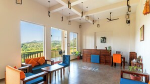 A spacious room with a balcony, a dining area, and a kitchen. - Kumbhal Exotica Resort Kumbhalgarh (Kumbhalgarh)