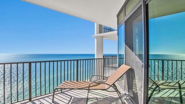 A balcony with a clear view of the ocean, a chair, and a glass door. - New to Rental Market! Beachfront!Lazy River!Oasis, Formerly Phoenix West II ! (Orange Beach)