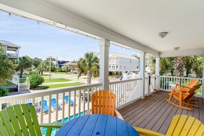 A wooden deck with a pool, outdoor seating, and a view of the neighborhood. - Large 6BR Home w/ Private Pool & Ocean Views (Surfside Beach)