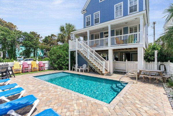 A two-story house with a swimming pool, outdoor seating, and a staircase leading to the upper floor. - Large 6BR Home w/ Private Pool & Ocean Views (Surfside Beach)