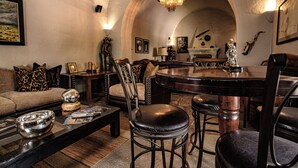 A cozy living room with a sofa, chairs, a coffee table, and a dining table with chairs.