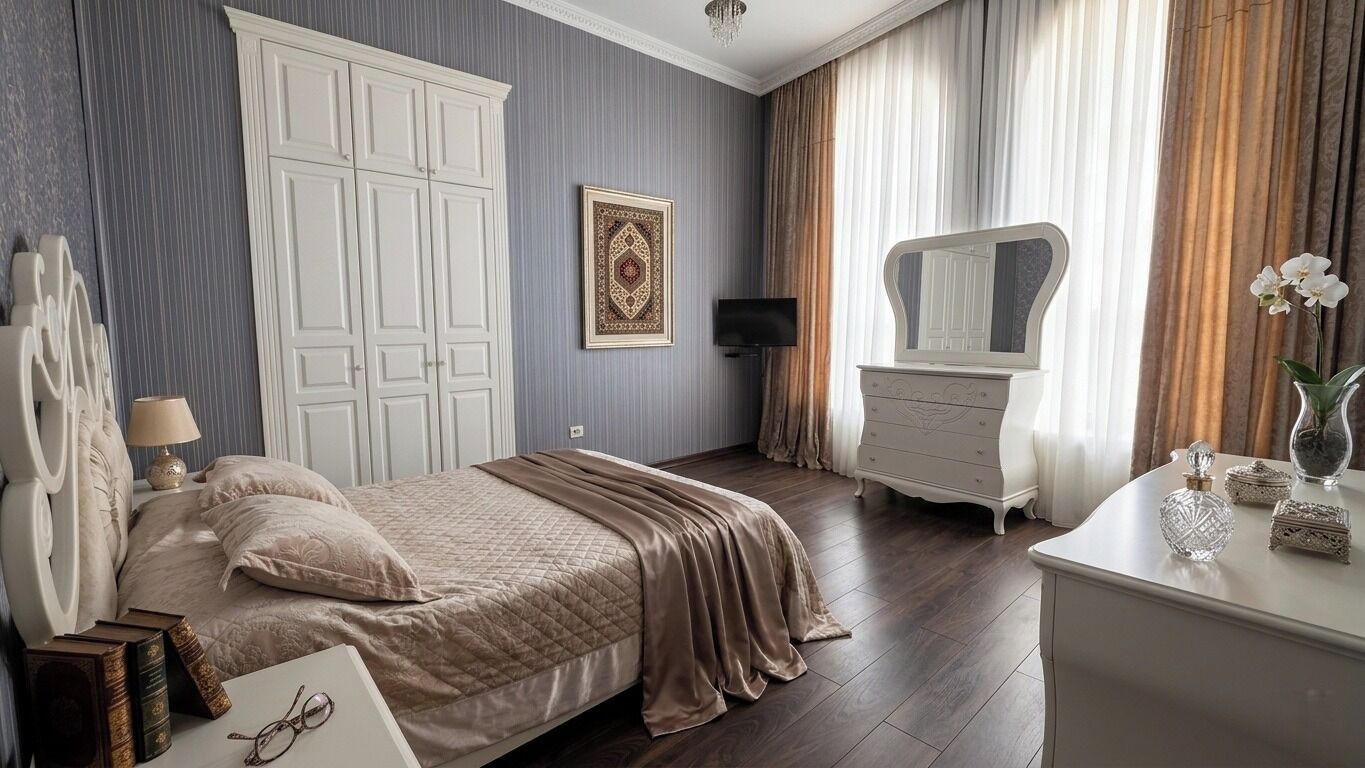 A bedroom with a bed, a dresser, a mirror, a framed picture, and a television.