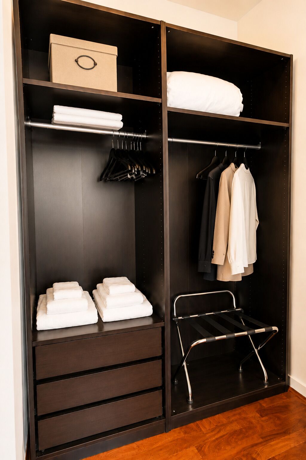 A walk-in closet with a metal rack, hanging space, and shelves for folded clothes.