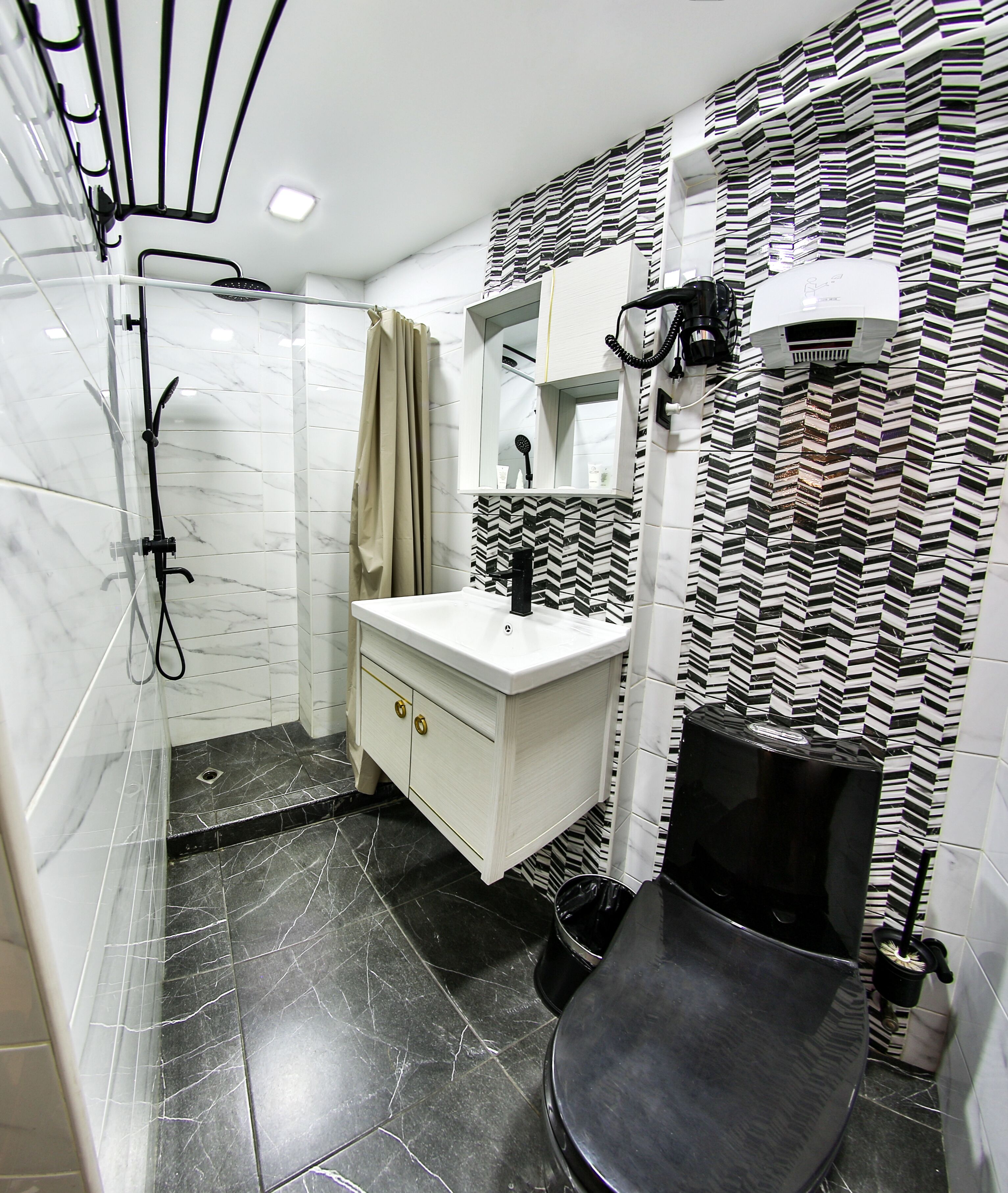 A bathroom with a shower, toilet, and sink.