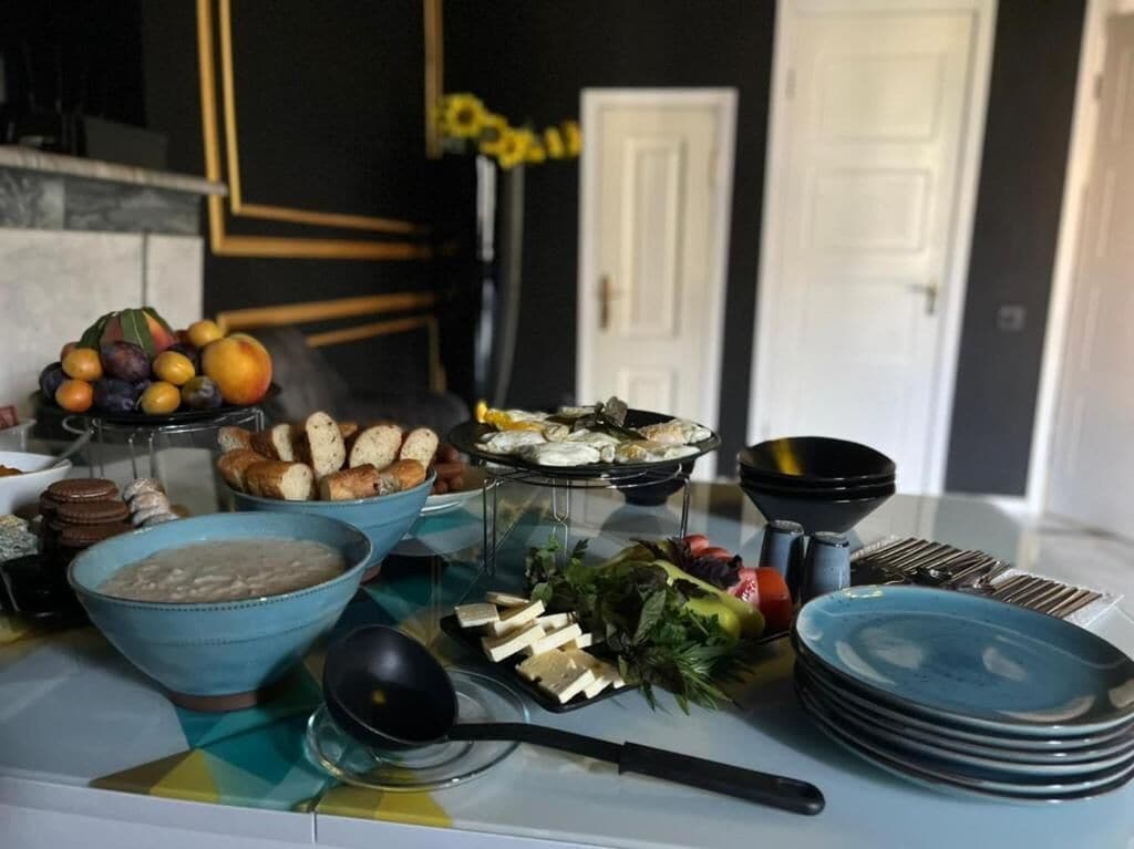 A buffet table with various food items and dishes.