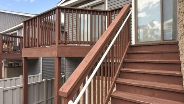 A wooden staircase with a railing leading to a deck area. - 2 Bedroom 2 Bath outdoor pool (Ocean City)