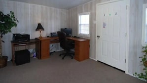 A room with a wooden desk, computer, and a window. - Enjoy Vacation in a Quiet Area w/ Huge Backyard! (Crosby)
