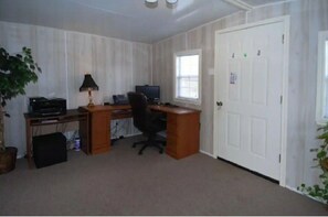 A room with a wooden desk, computer, and a window. - Enjoy Vacation in a Quiet Area w/ Huge Backyard! (Crosby)
