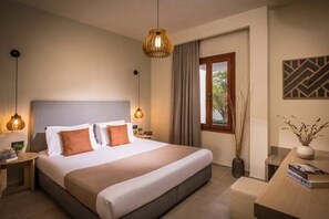 A modern hotel room with a large bed, bedside tables, a desk, and a window with curtains. - Malena Hotel and Suites - Adults Only by Omilos Hotels (Malevizi)