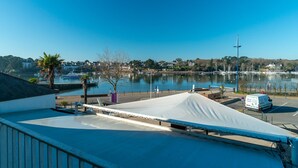 A marina with boats, a white tent, and a van in the parking lot. - France - Appt pour 4 proche plage (Benodet)