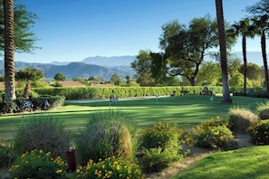 A golf course with a clear sky, mountains in the background, and well-maintained greenery. - The Westin Mission Hills Resort Villas, Palm Springs (Rancho Mirage)
