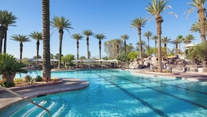 A swimming pool with clear blue water, surrounded by palm trees and a rocky landscape. - The Westin Mission Hills Resort Villas, Palm Springs (Rancho Mirage)