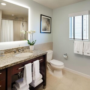 A bathroom with a granite countertop sink, a toilet, a shower, and a window with blinds. - The Westin Mission Hills Resort Villas, Palm Springs (Rancho Mirage)
