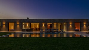 A modern building with a swimming pool, outdoor seating, and multiple entryways. - PEPE, luxury and modern villa with private pool (5 bdrms/10 guests) (Marrakech)