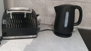 A kitchen with a toaster and a kettle on the countertop. - Studio Flat in Lovely Alexandra Palace, London (London)