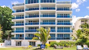 A multi-story hotel with a modern design, featuring balconies and large windows. - 501 Ocean front condo at Ocean One Maxwell coast road Barbados (Oistins)