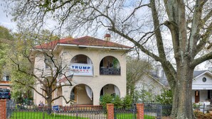 A two-story house with a red roof, a sign reading "TRUMP", and a brick fence. - Stay just 3 miles from Augusta National during Masters Week! (Augusta)