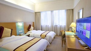 A hotel room with two beds, a desk, a television, and a window with curtains. - Carrianna (Foshan)