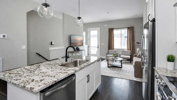 A modern kitchen with granite countertops, stainless steel appliances, and pendant lighting. - Music City Luxe Stay • Rooftop & Hot Tub (Nashville)