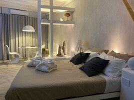 Deluxe Suite | 1 bedroom, down comforters, in-room safe, individually decorated