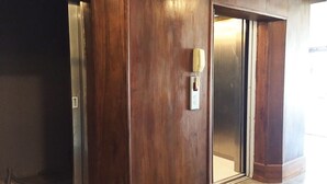 A wooden door with a keyhole and a small electronic device attached to it.