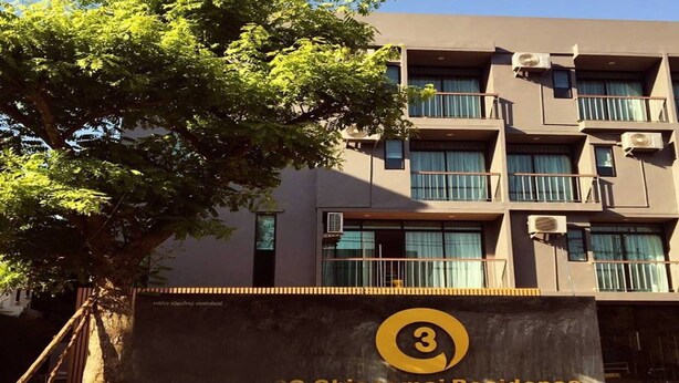A multi-story building with balconies and air conditioning units, labeled as '3Q Chiangmai Residence'.