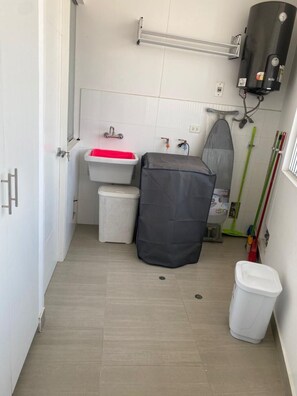 Bathroom features a white sink, toilet, and shower curtain.