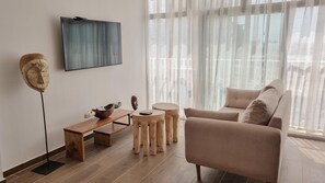 Deluxe Apartment, 1 Bedroom, Bay View | Living area | 50-inch Smart TV with satellite channels, TV
