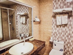 A bathroom with a sink, mirror, shower, and toilet. - Greentree Inn Jiayuguan Xinhua Nan Road (Jiayuguan)